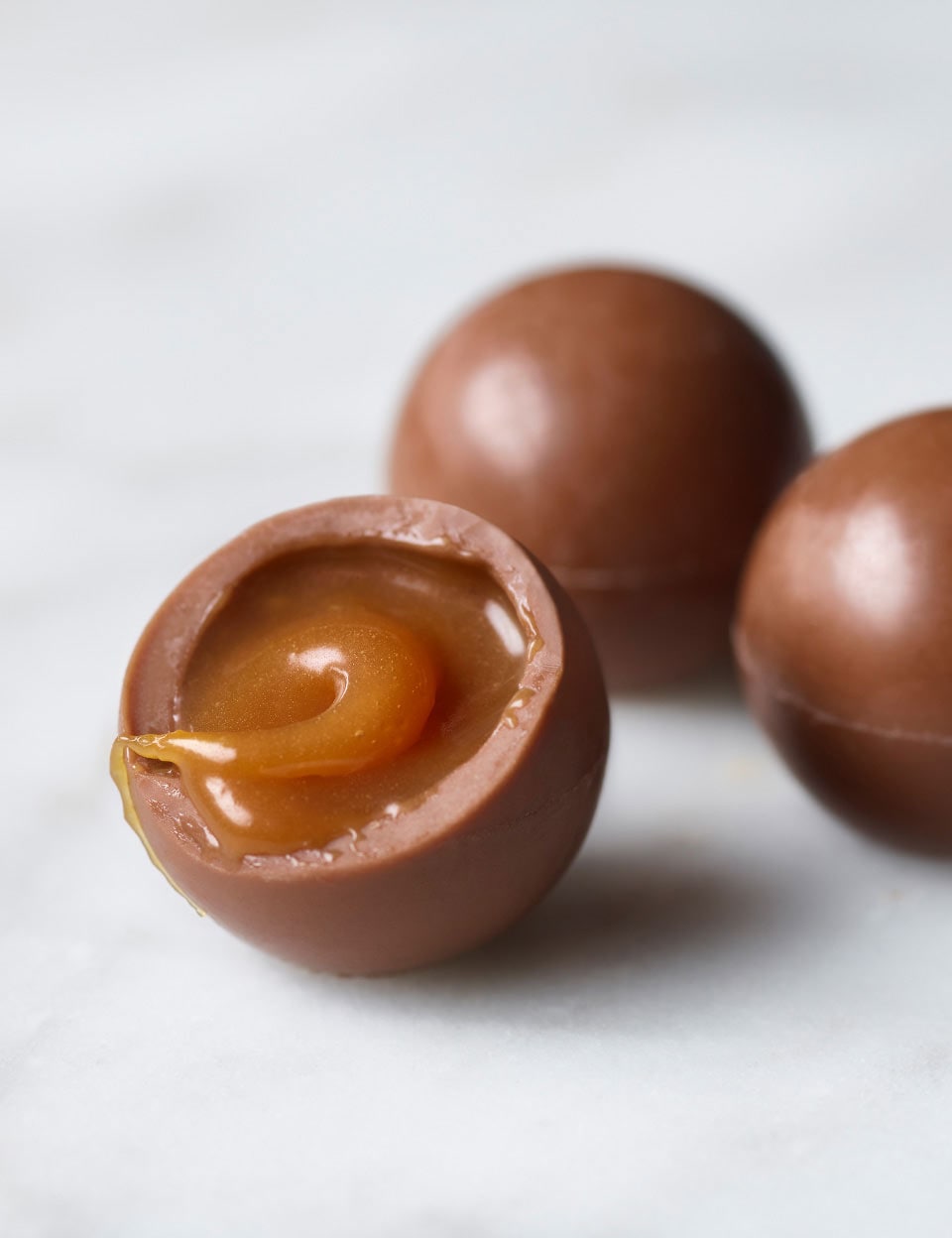 A group of Thorntons Pearls chocolates on a marble surface.