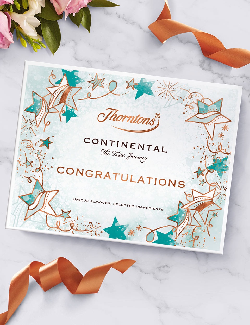 Thorntons Continental box with a congratulations gift sleeve on a marble table