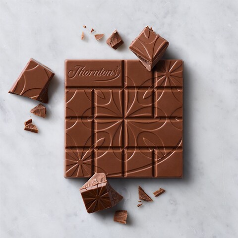 Overhead of a milk chocolate Thorntons Chocolate Block on a marble surface.
