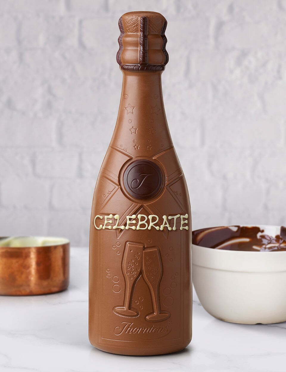 Thorntons milk chocolate bottle hand iced with the words celebrate