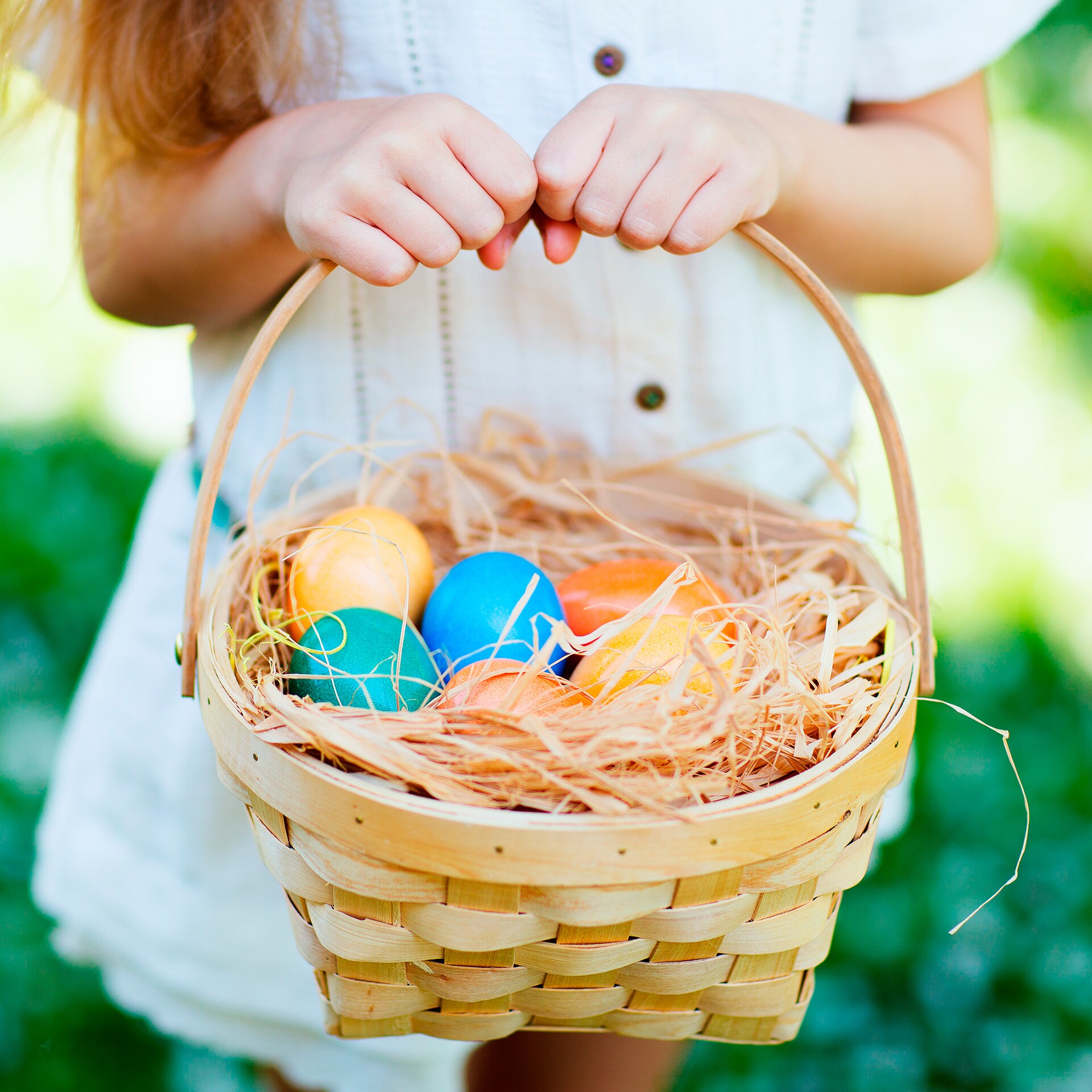 Girl holding Easter egg hunt basket