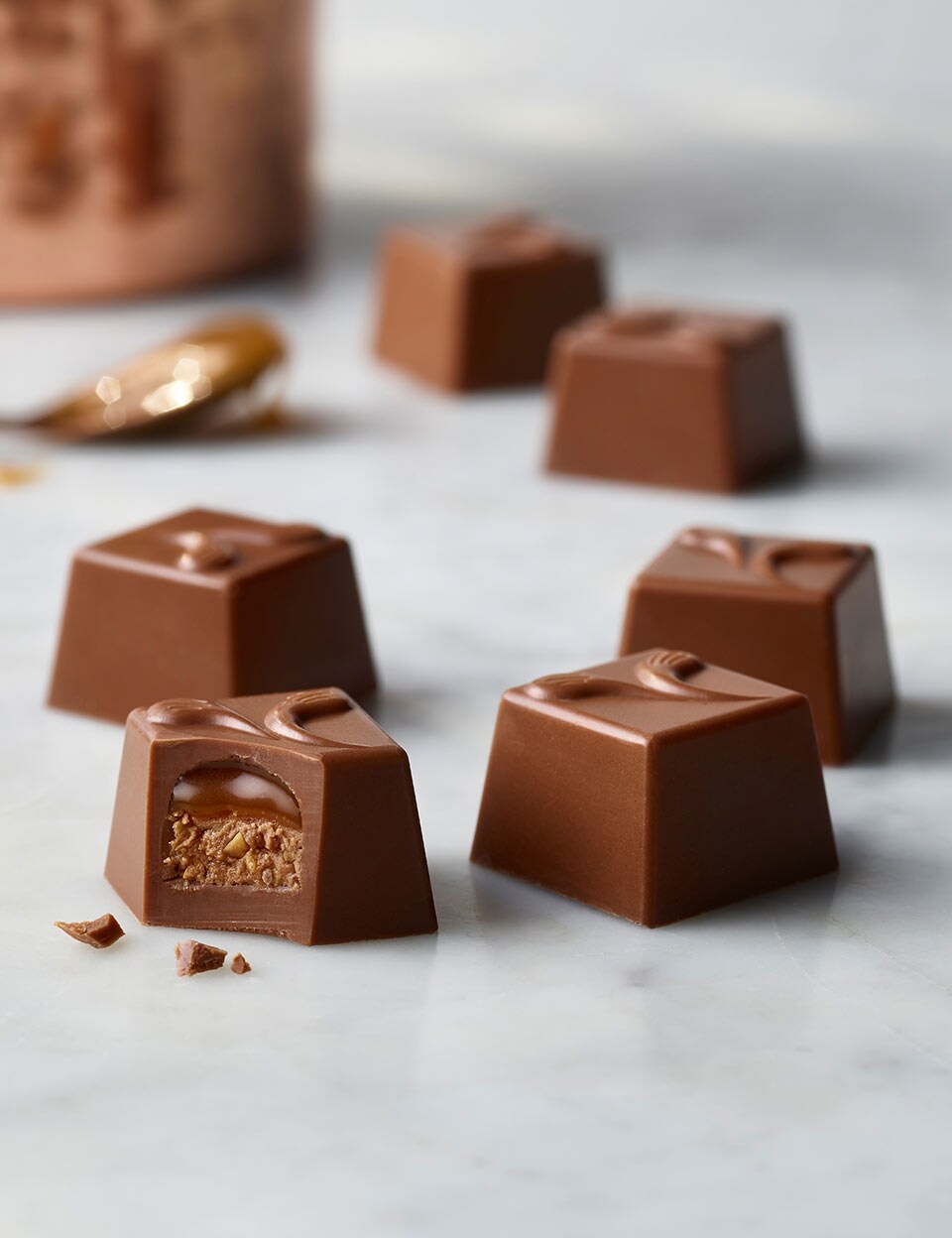 Continental Salted Caramel chocolates grouped on a marble table