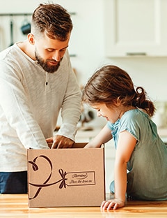 Dad and daughter opening box