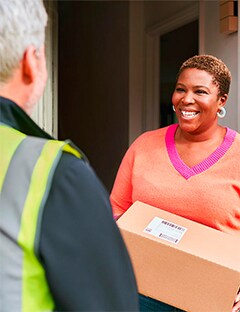Lady receiving an Evri delivery for Thorntons