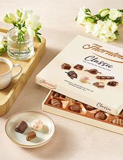 A slightly opened box of Classic Collection chocolates on a table.